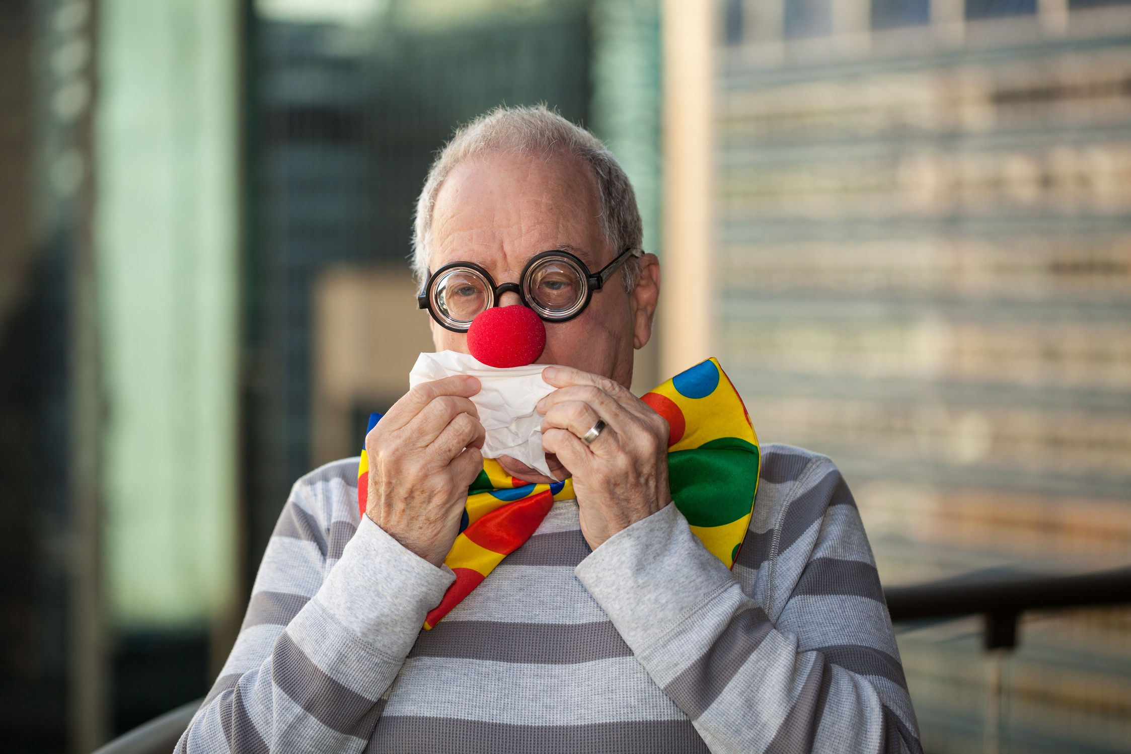 Office clown trying to blow his nose.