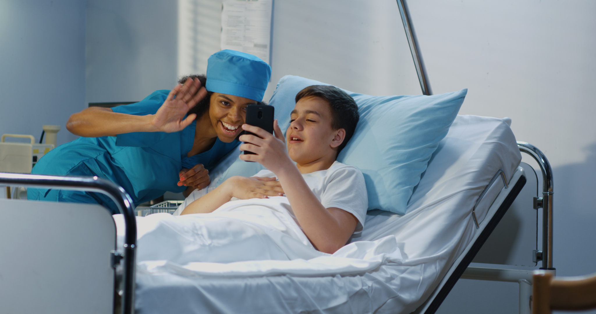 Teenager patient using cell phone in hospital