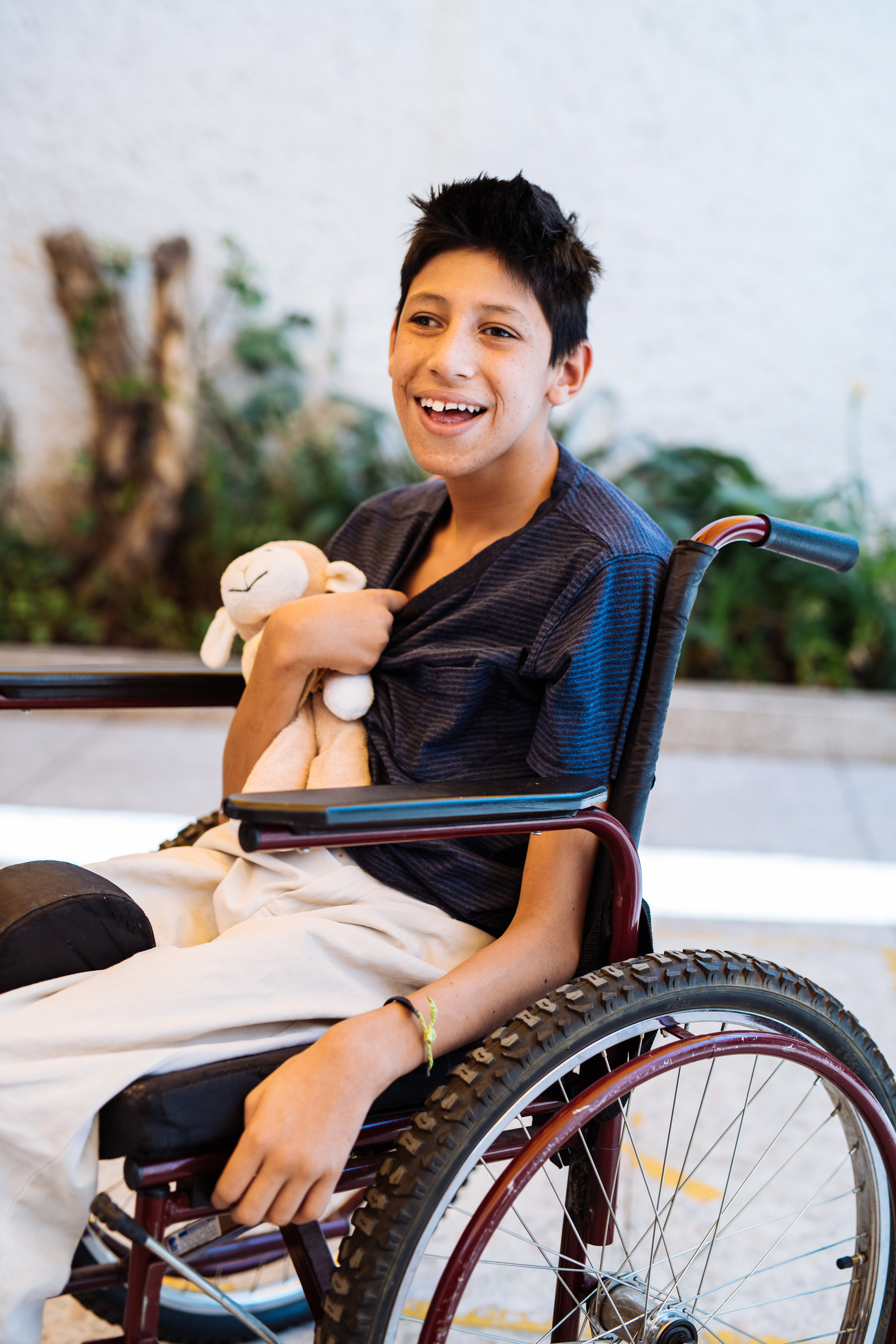 Portrait of Latino teenager in wheelchair with Celebral Palsy.